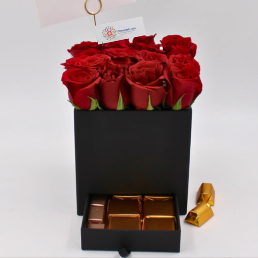 Red Roses in a black box and chocolate